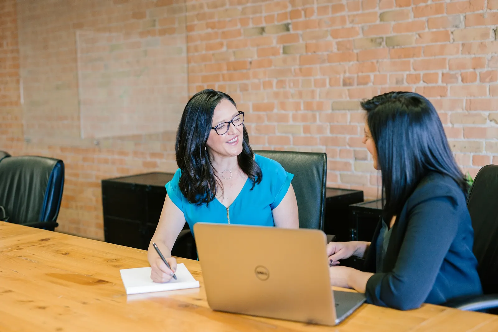 Sesión de coaching profesional entre dos personas trabajando con un portátil